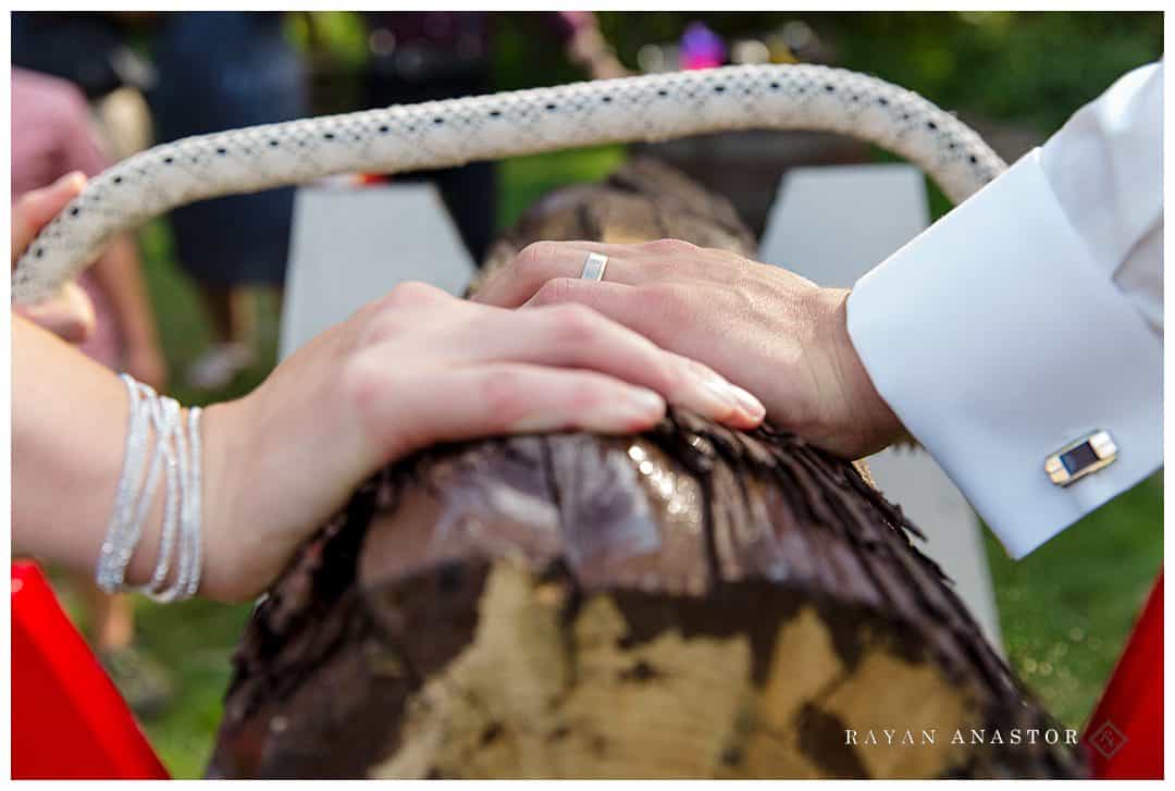 bride and grooms sawing log at German wedding