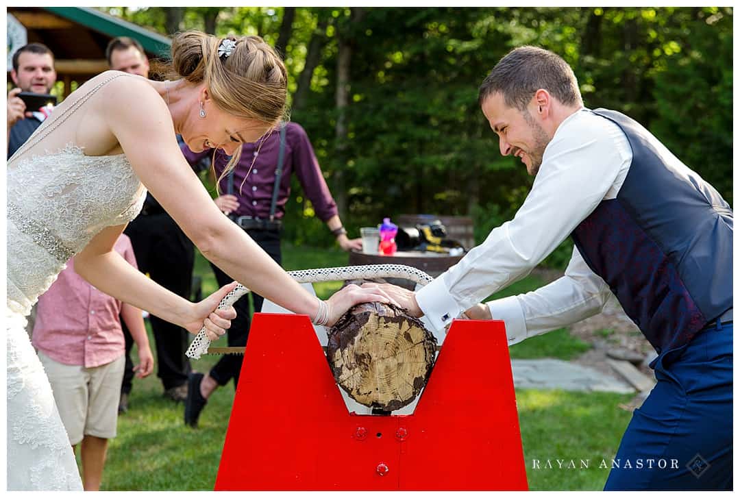 bride and grooms sawing log at German wedding