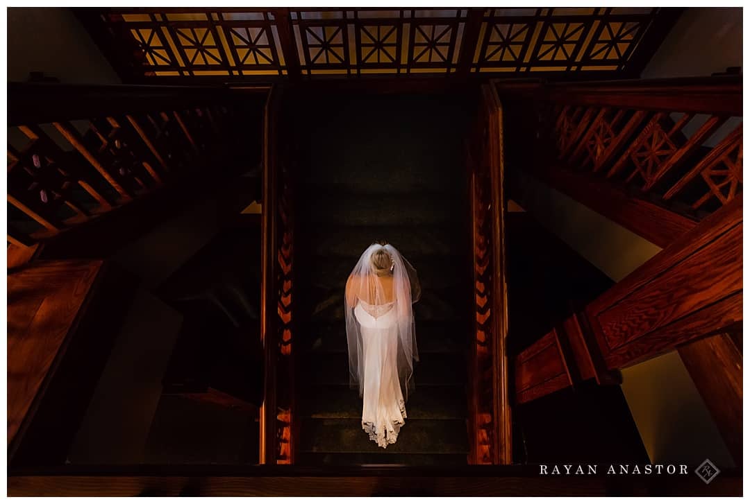 bride walking up stairs to her wedding in traverse city