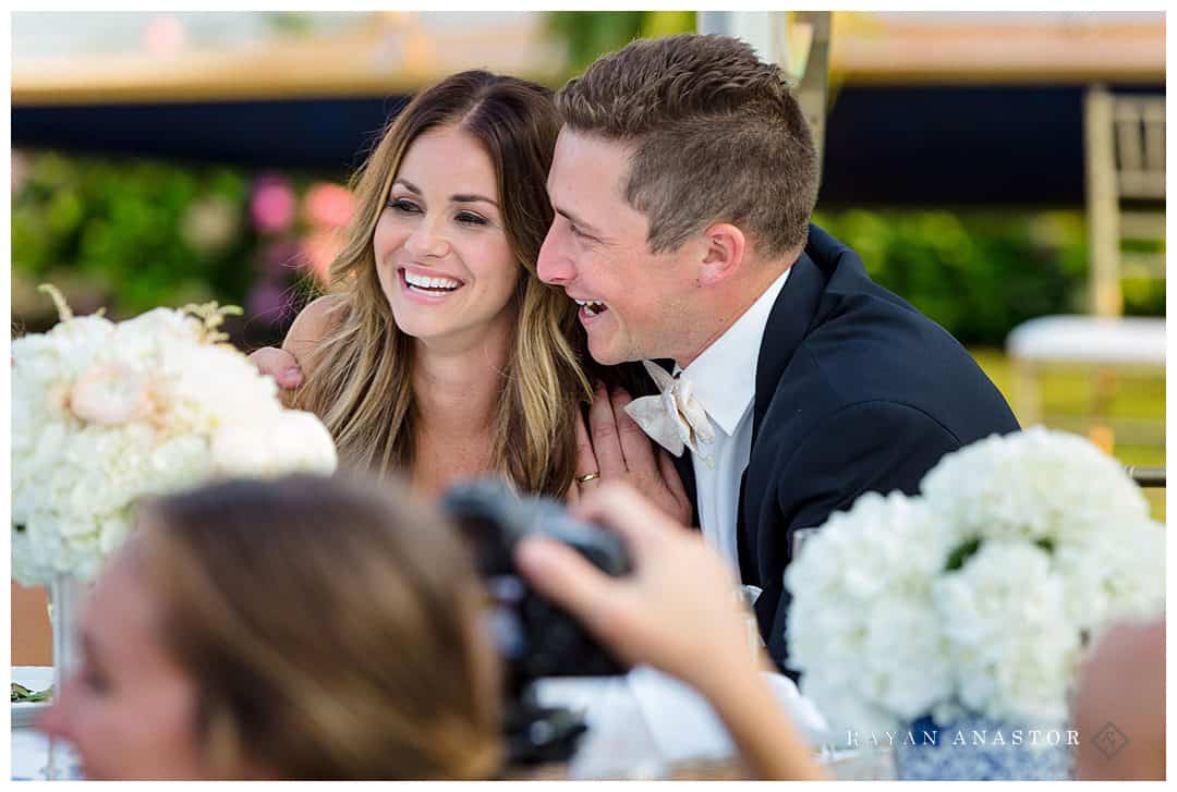 bride and groom laughing during toasts