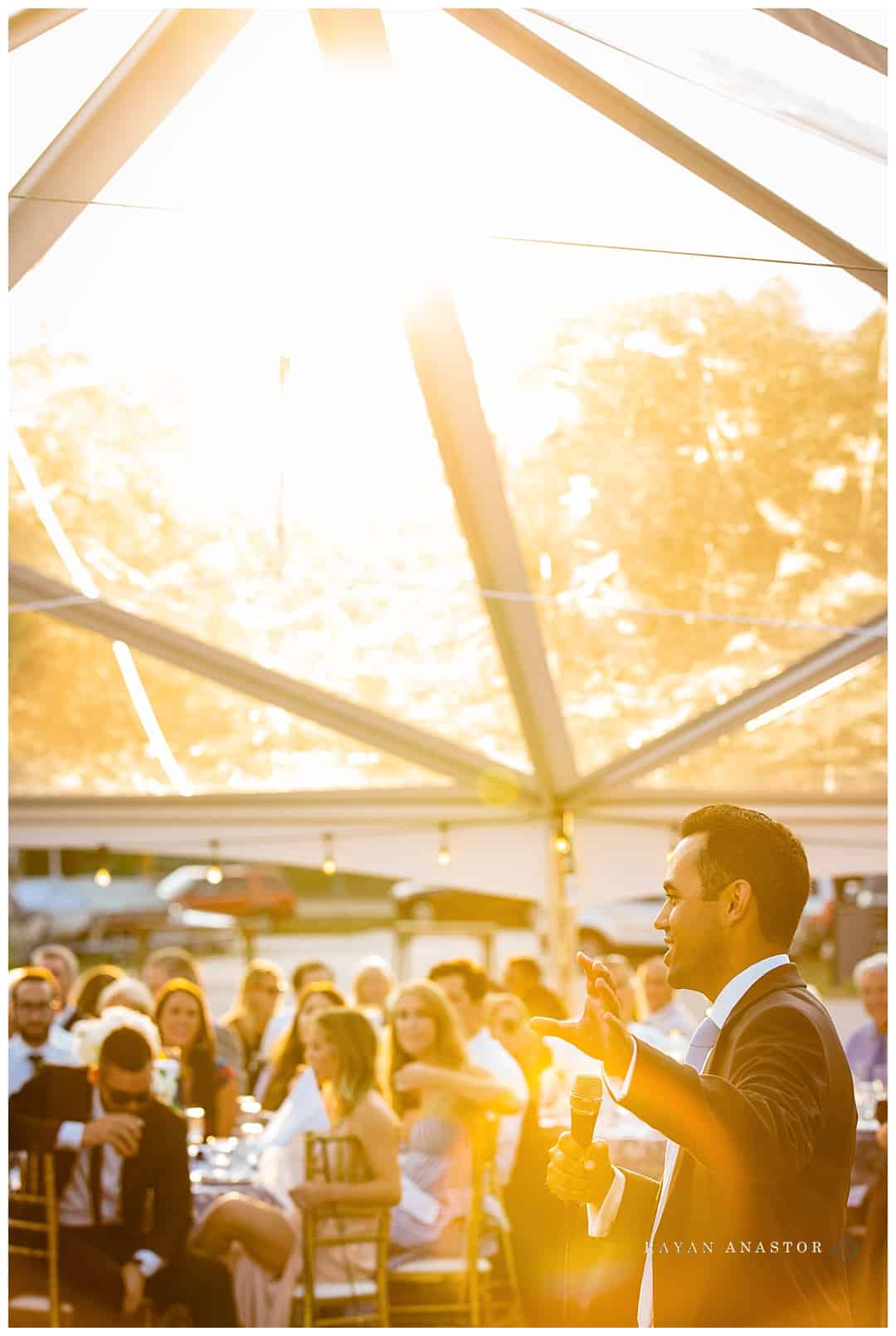 Sunset toasts under a clear tent