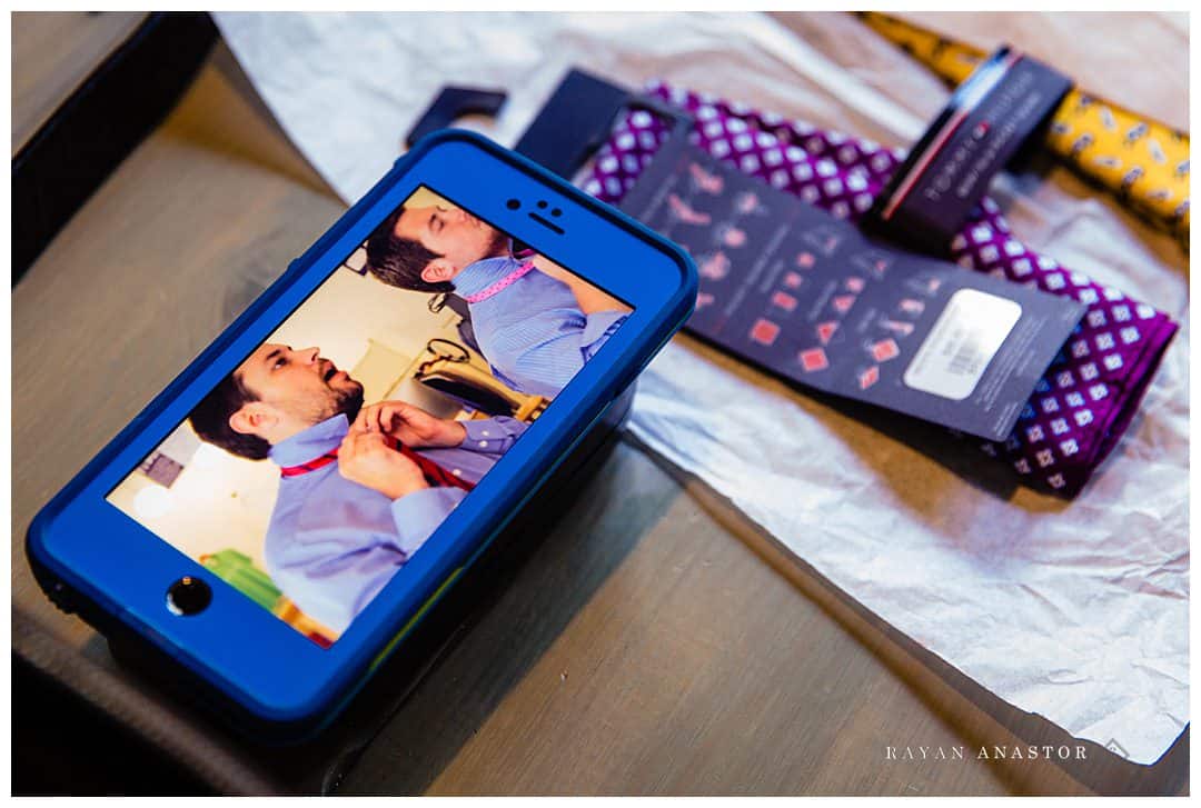 groom using youtube to figure out how to tie a tie