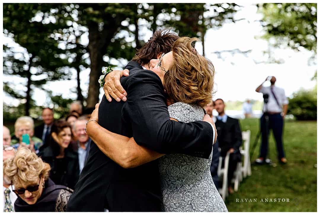 groom and mom hugging