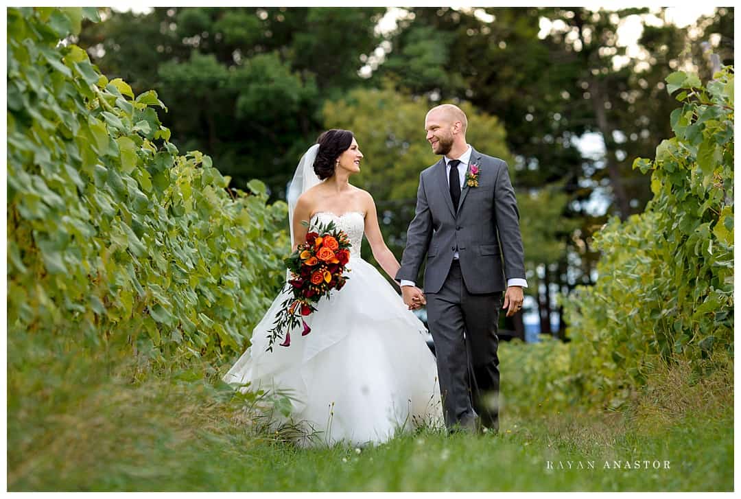 bride and groom in vineyard on old mission peninsula