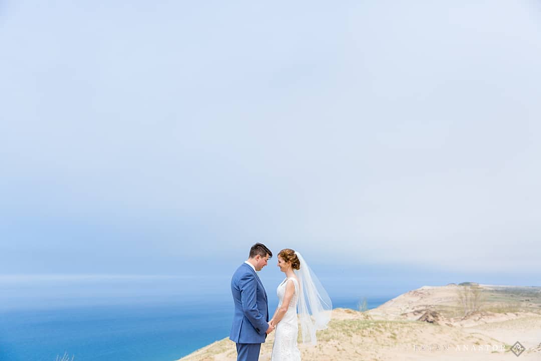 bride and groom in sand dunes at Lake Michigan