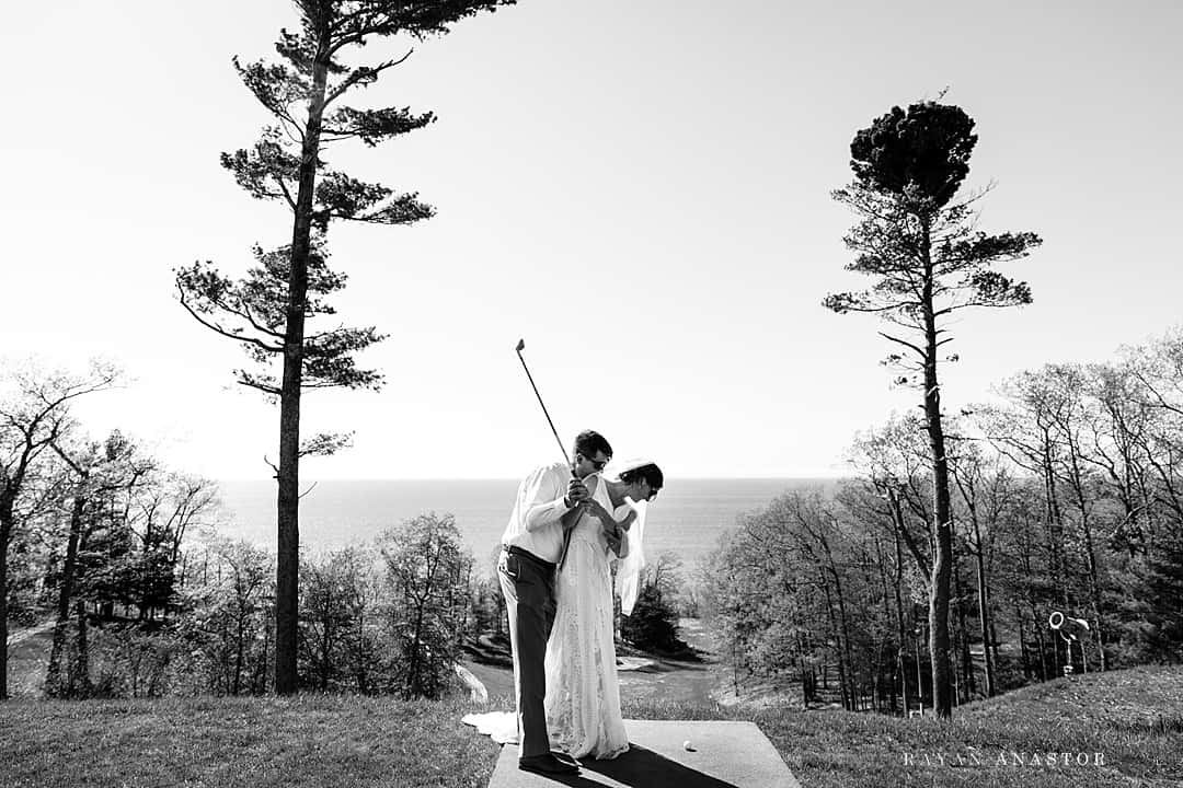 bride and groom golfing closest to the tee
