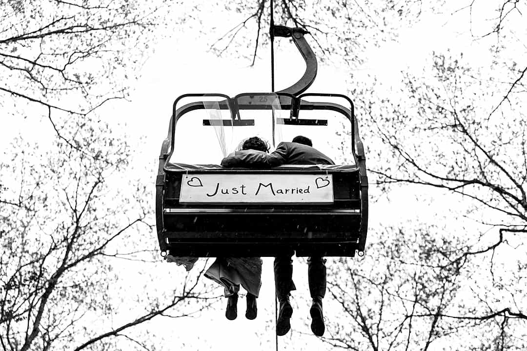bride and groom riding chair lift