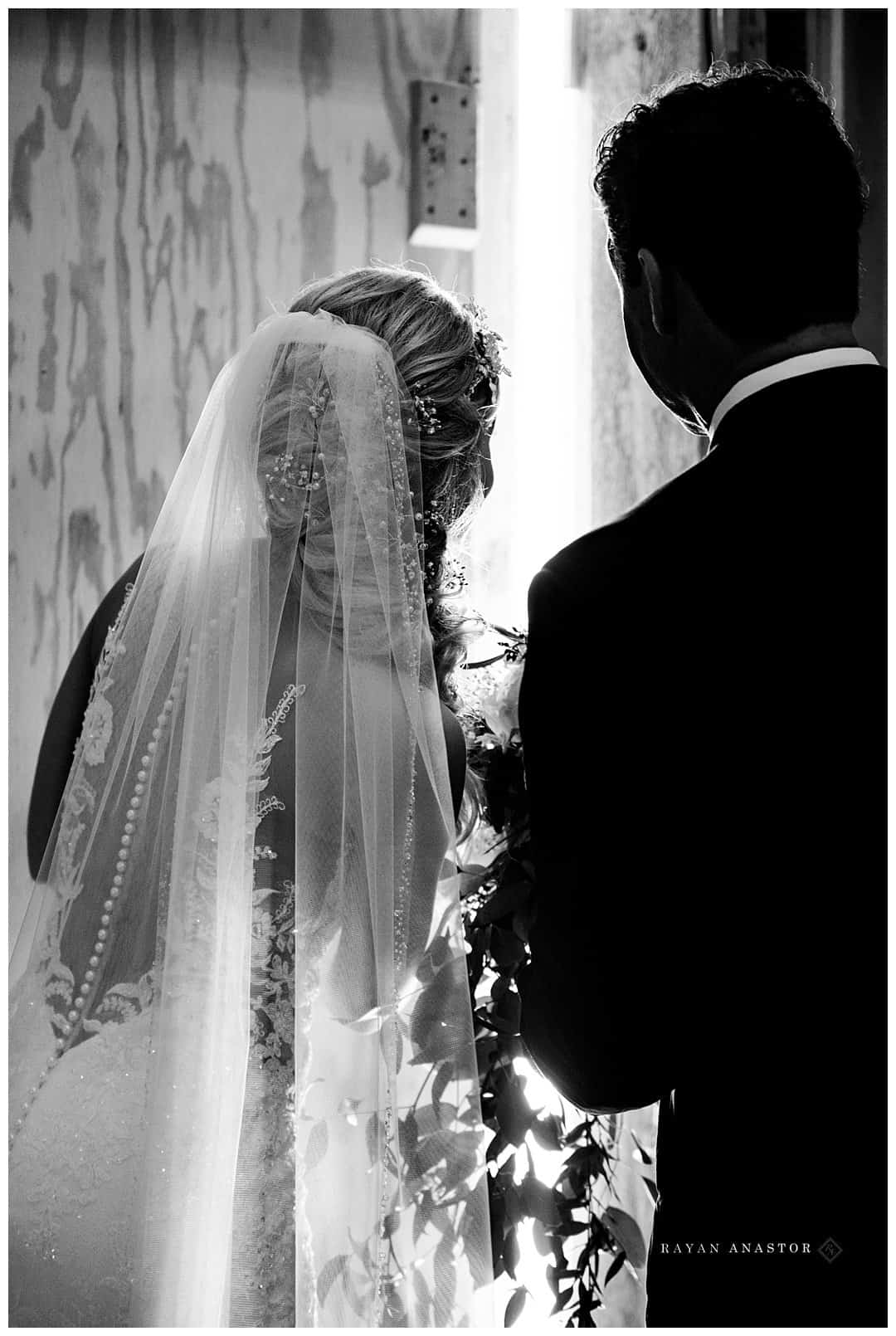 bride watching as ceremony gets ready to start with father