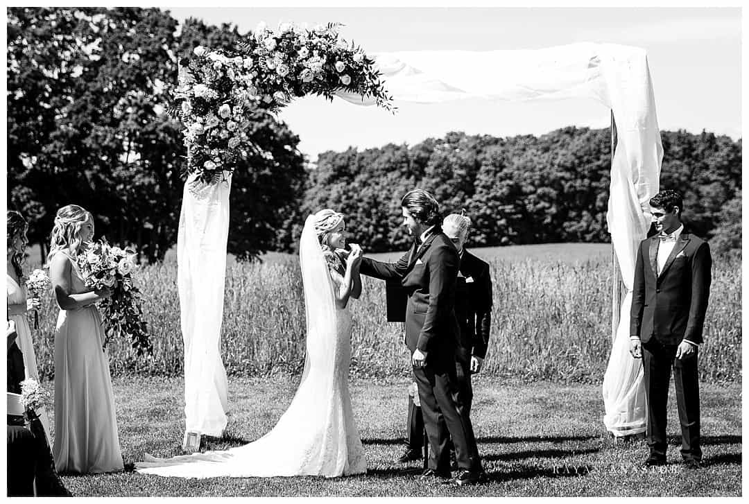 groom wiping tear from bride