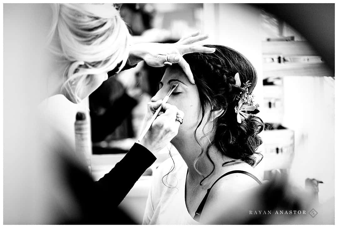 Bride having eye makeup applied