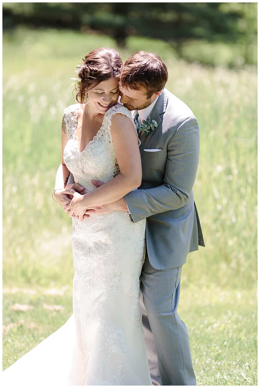 bride and groom in grassy field