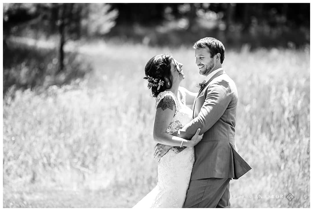 bride and groom in grassy field