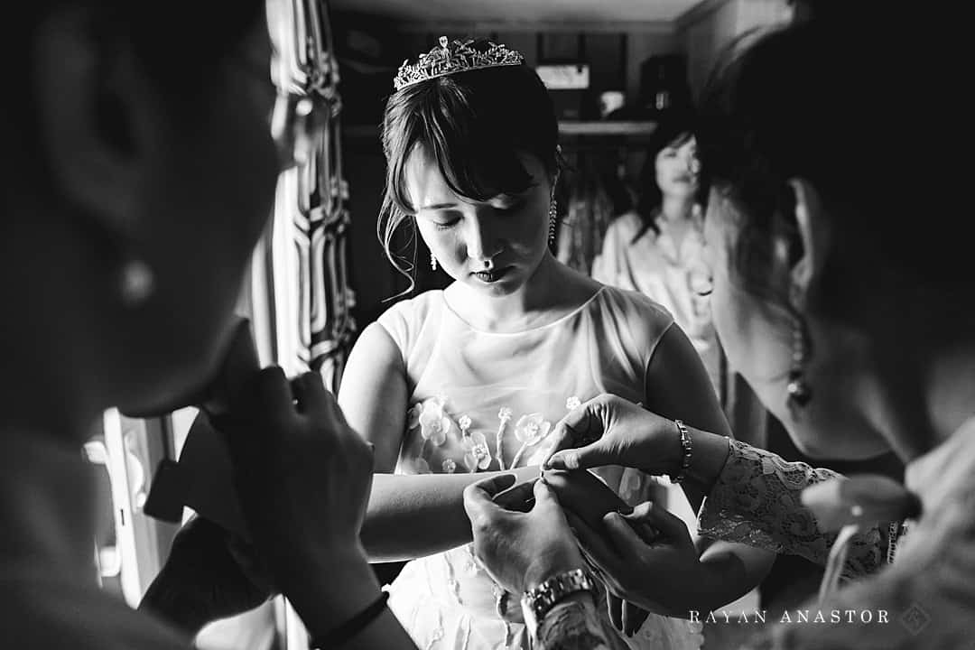 mother and aunt helping bride get ready
