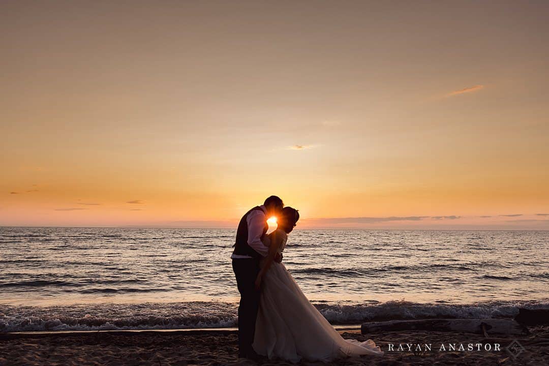 bride and groom at sunset on Lake Michigan