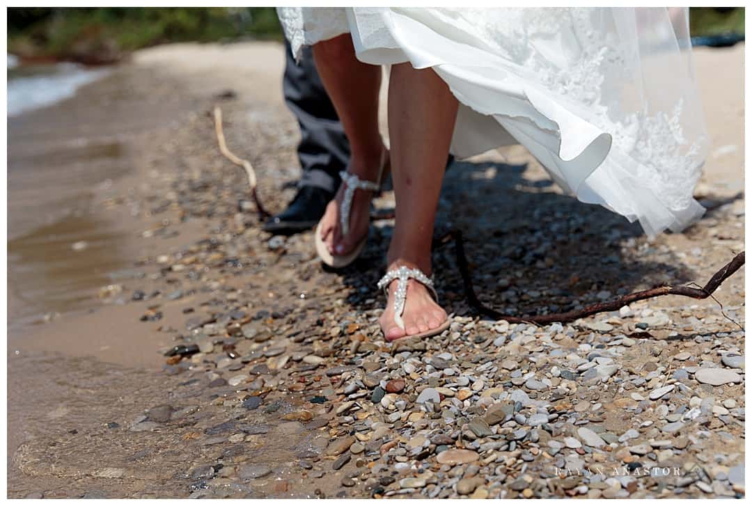 bride and groom walking the beach at lake Michigan