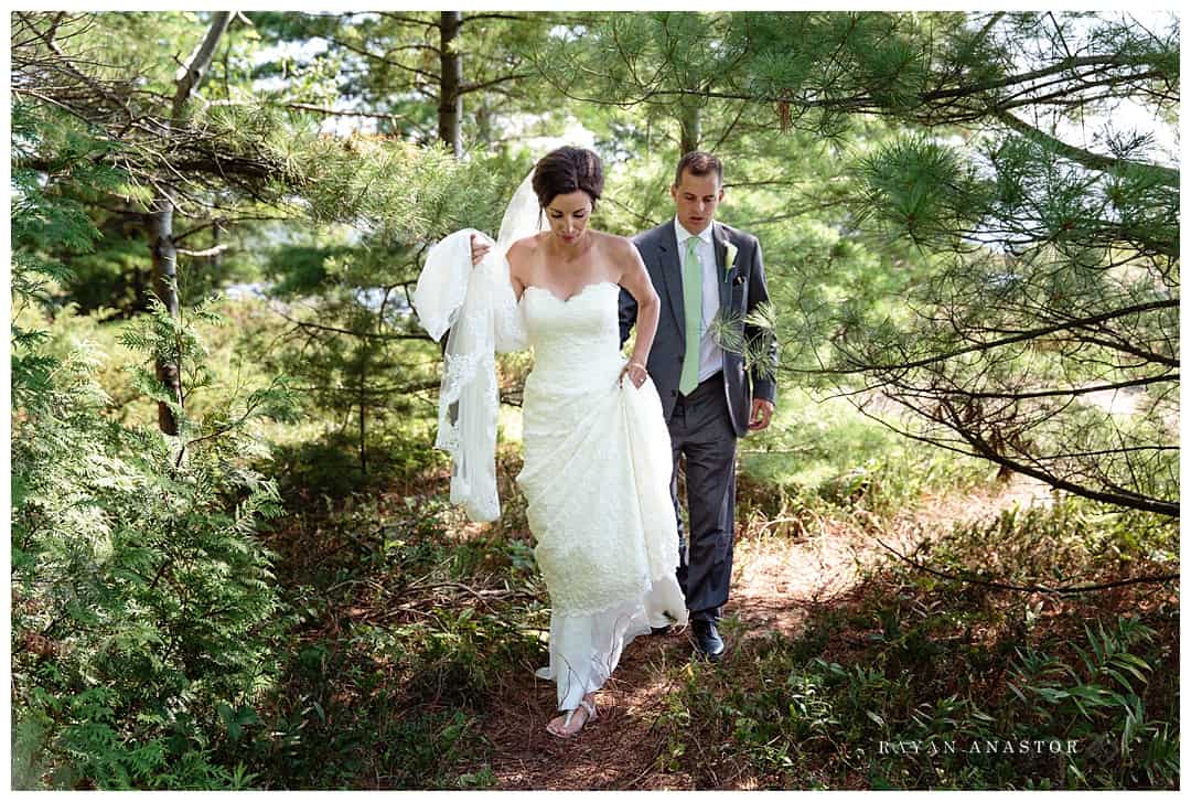 bride and groom walking a path to photo location