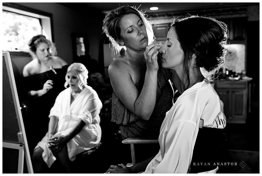 bride and her mother having makeup done