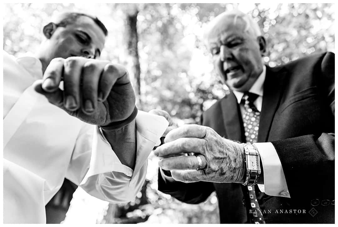 groom and dad putting on cuff links