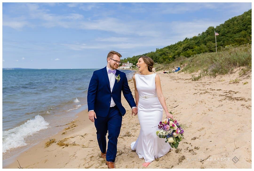 bride and groom laughing on Lake Michigan