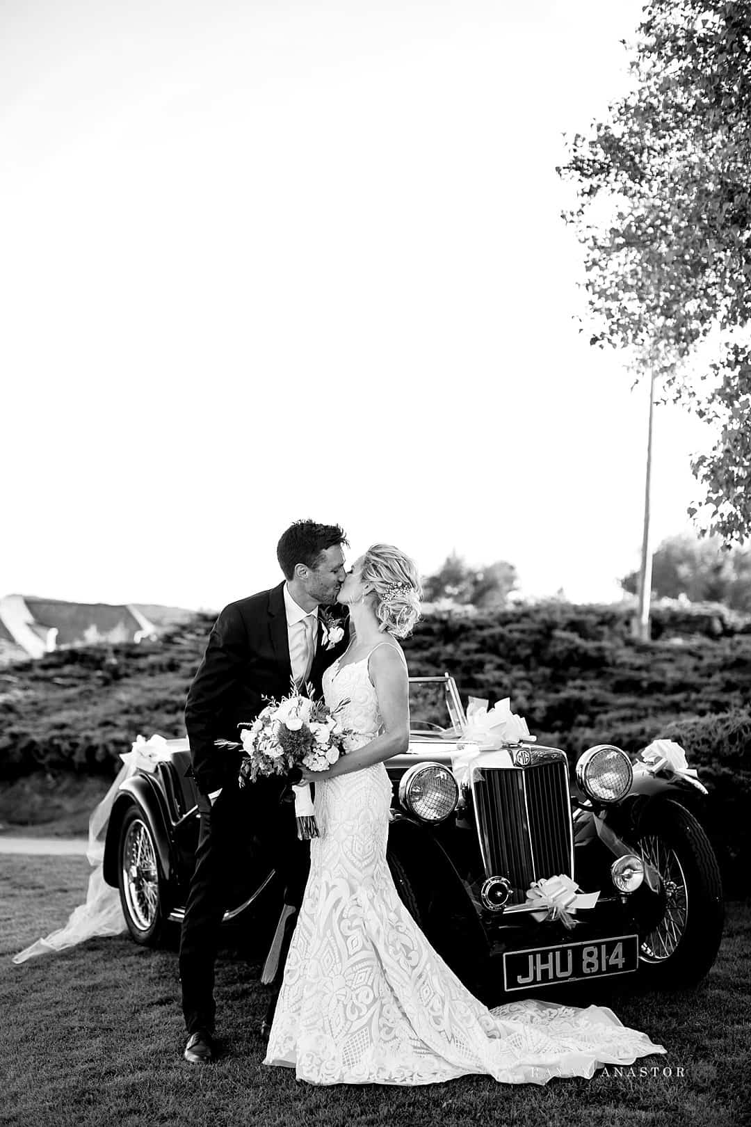 bride and groom leaving in classic car
