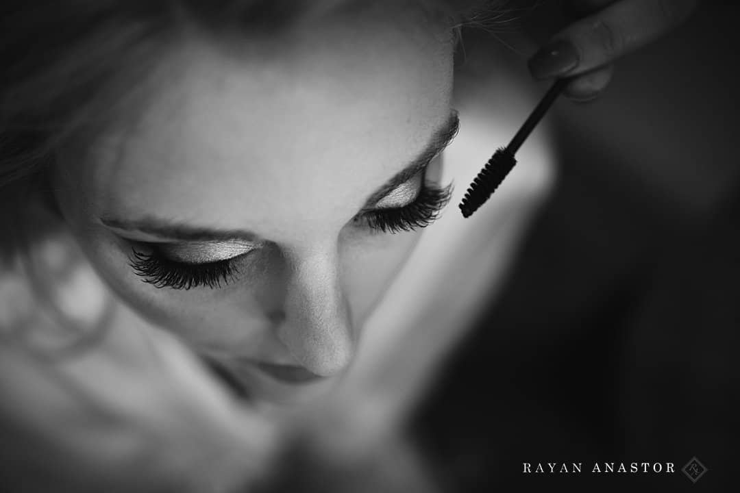 bride having eye makeup done by Megan Grimm with VIVE