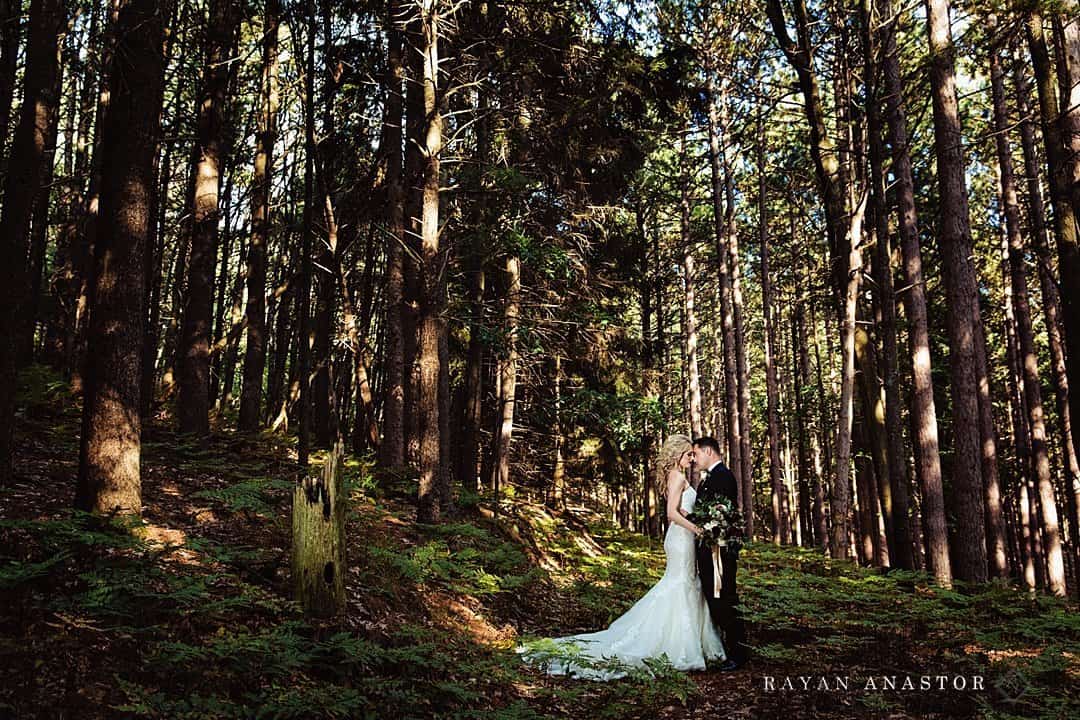 bride and groom in hardwoods for wedding photos