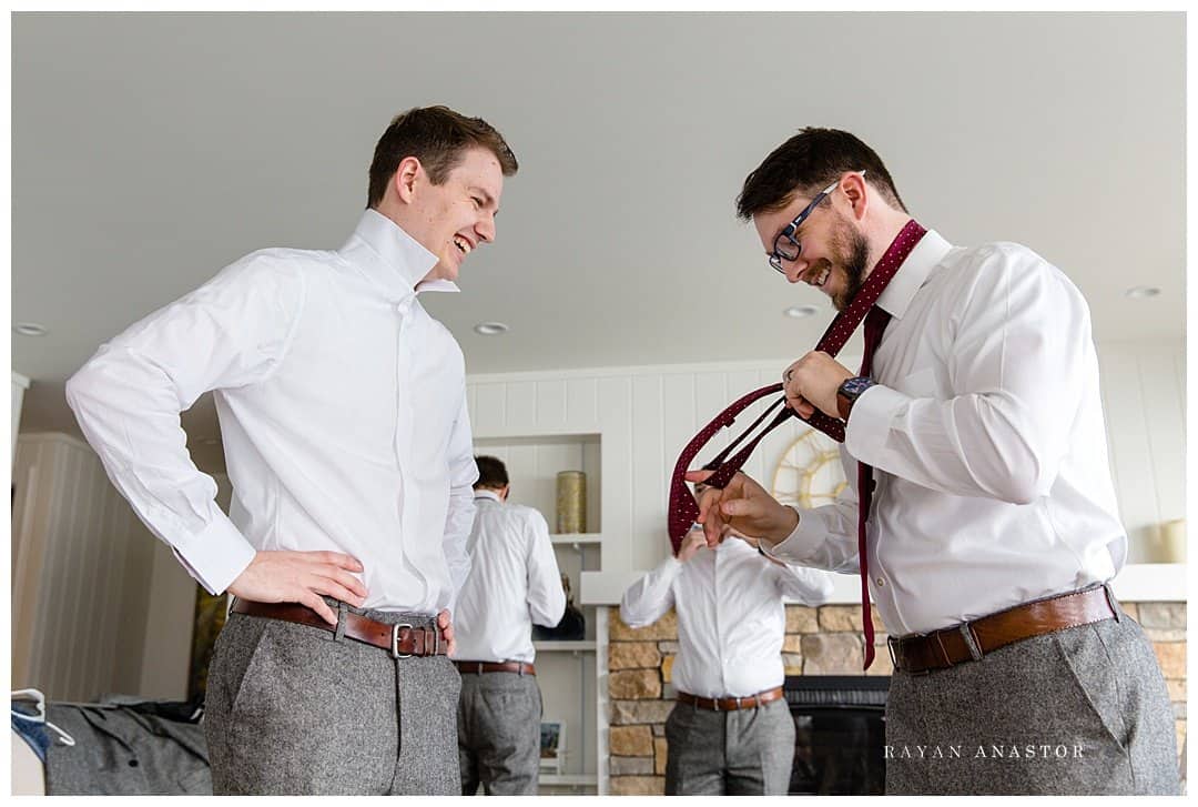 groom getting ready for wedding at private residence