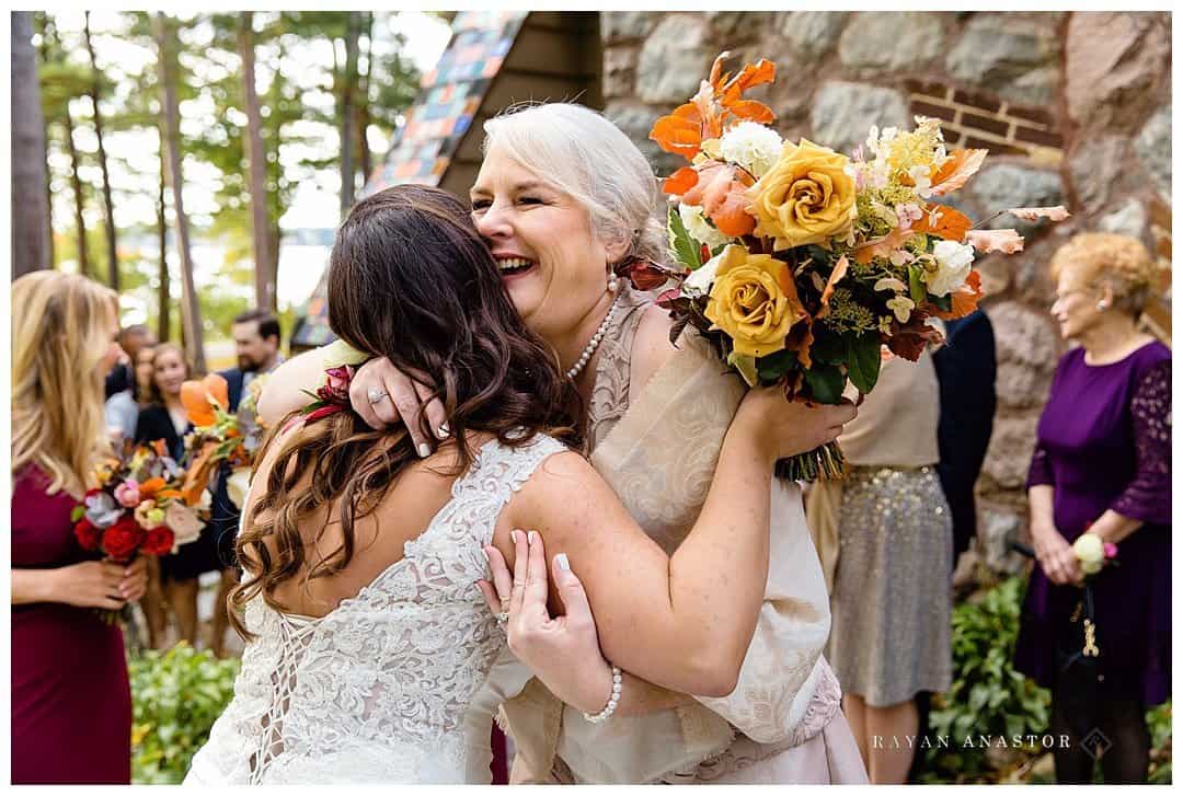 mother hugging daughter after wedding with Bloom Florals
