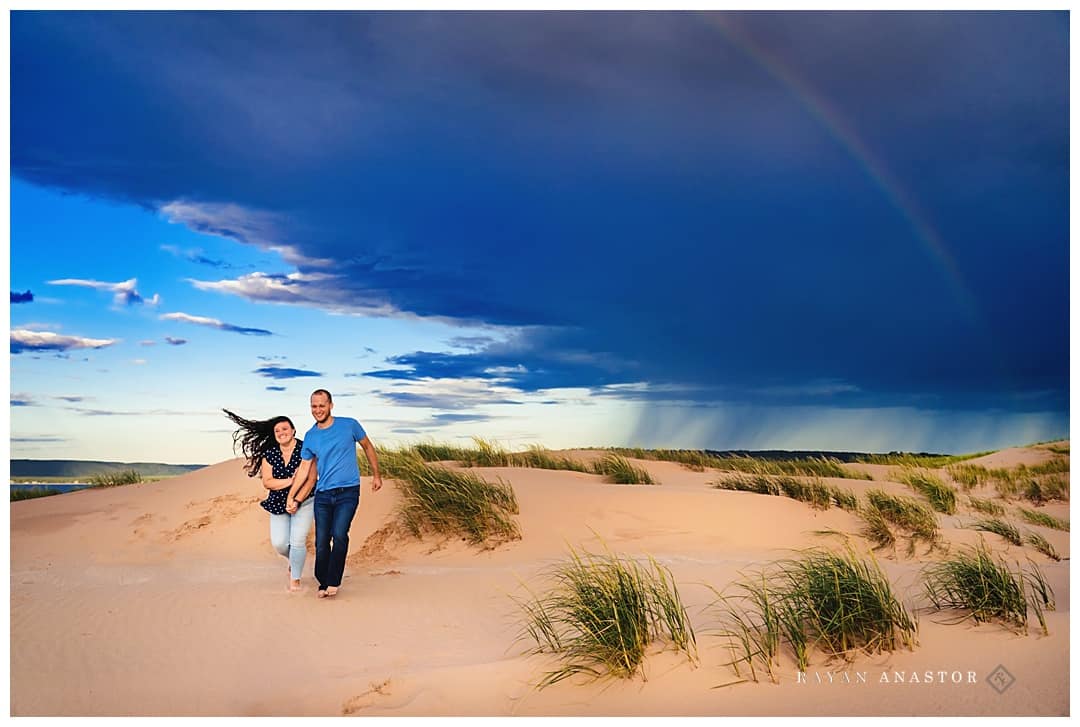 Storm and rainbow in sleeping bear dunes engagement photo