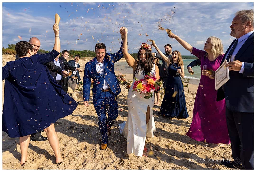 bride and groom just married and flower petals thrown on them