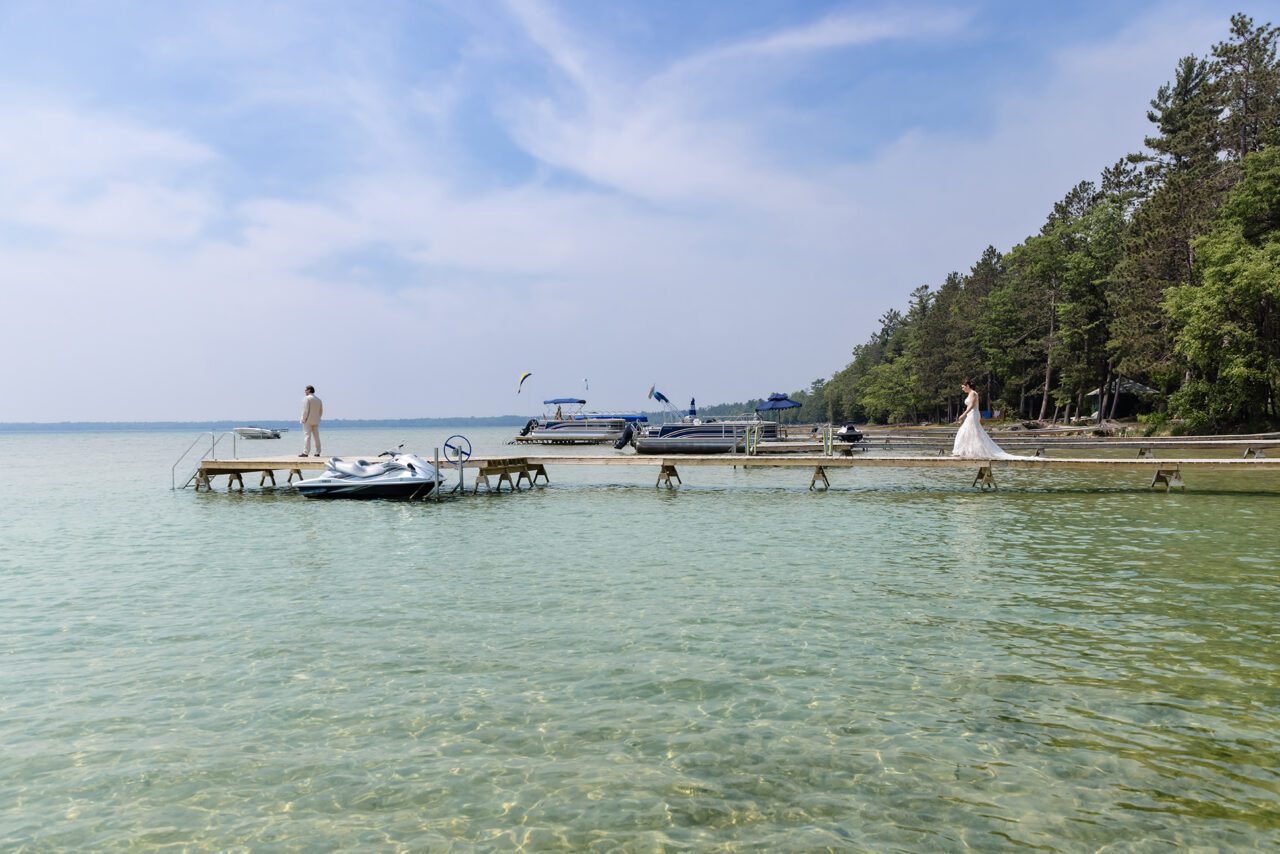 Bride and Groom having their first look on Higgin's Lake Dock