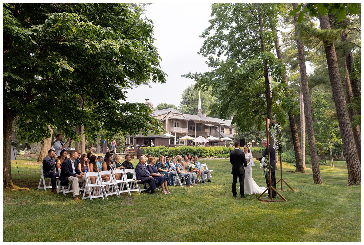 wedding ceremony on front lawn of mission table