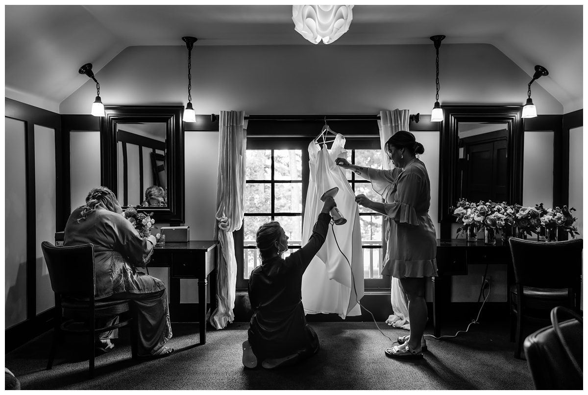 bridesmaids steaming wedding gown on old mission peninsula