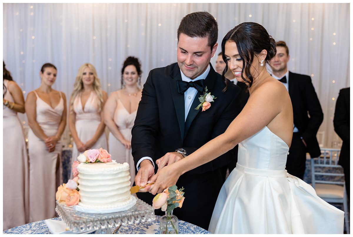 cutting the wedding cake at the Charlevoix Yacht Club