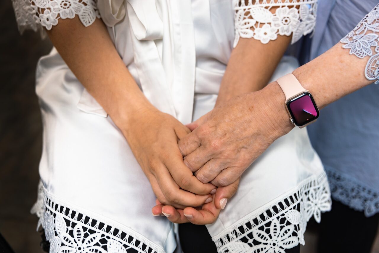 Cadillac Michigan Wedding where bride holding hands with mother before wedding