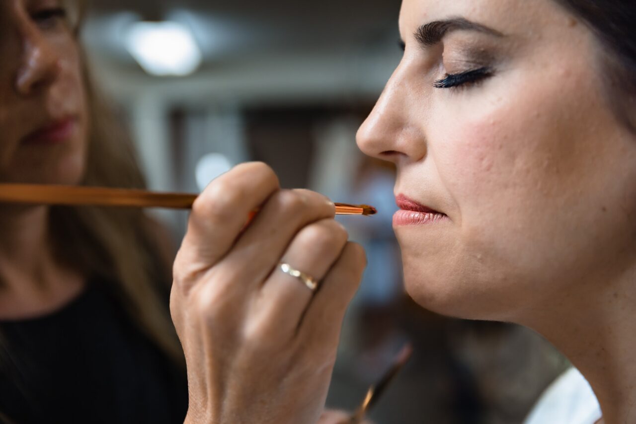 bride having makeup done at caberfae peaks