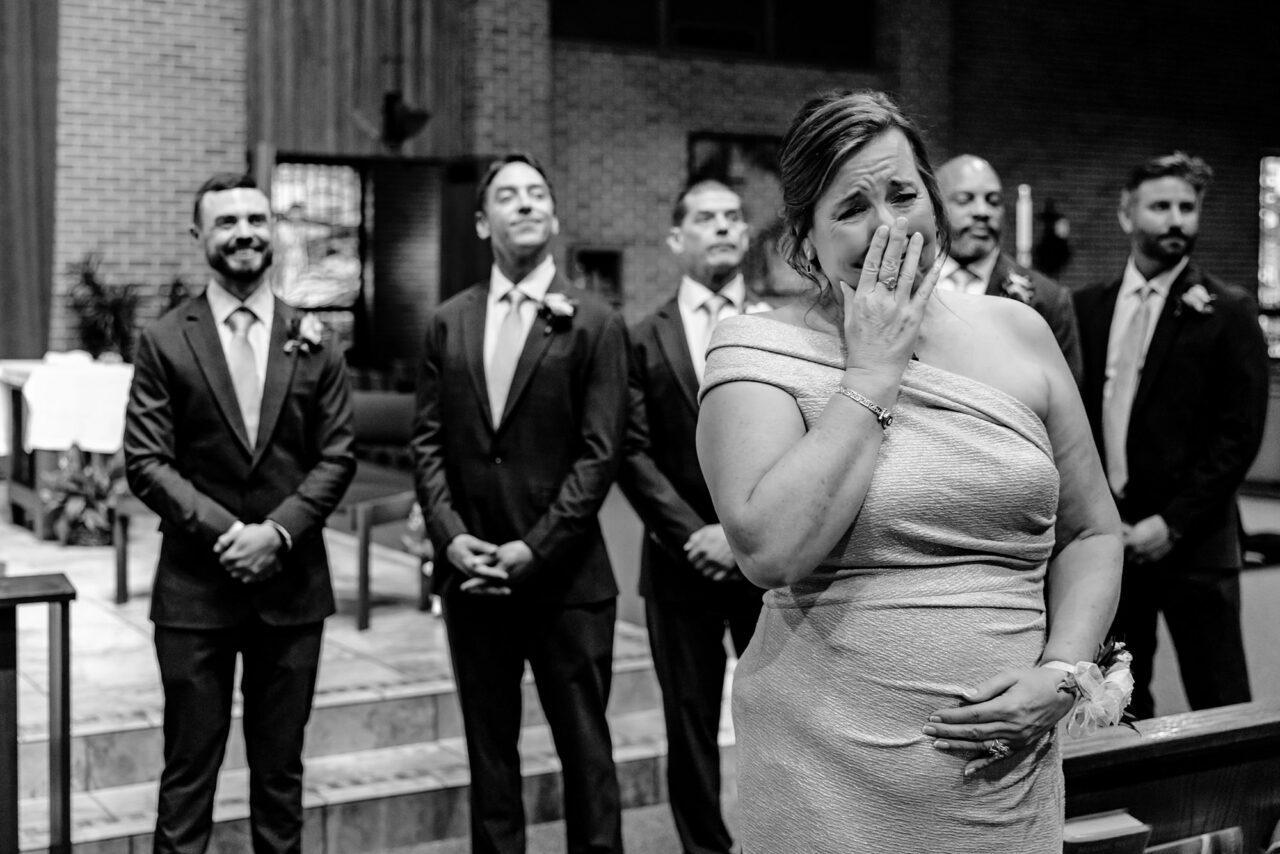 mother crying as bride walks down the aisle