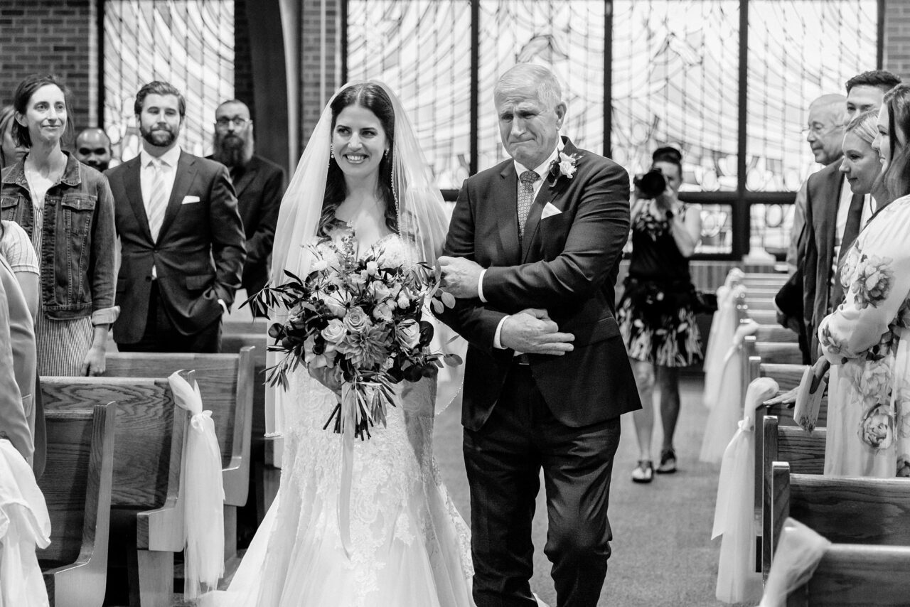 father of bride crying as he walks her down the aisle
