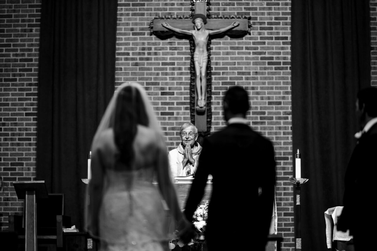 bride and groom during catholic ceremony in Cadillac