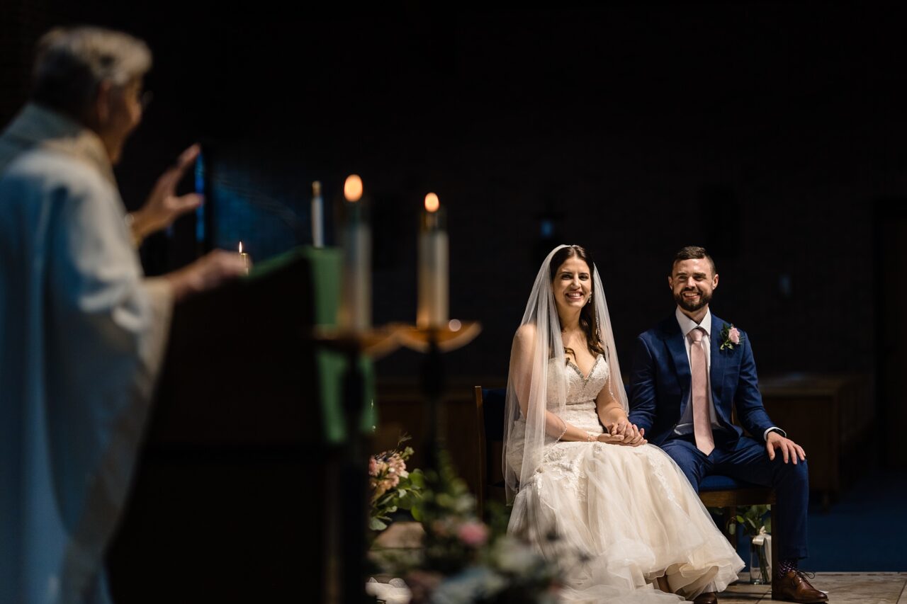 bride and groom during catholic ceremony in Cadillac