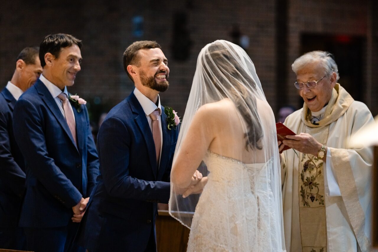 bride and groom during catholic ceremony in Cadillac