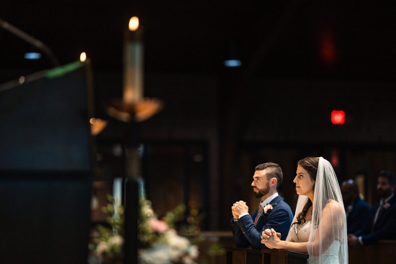 bride and groom during catholic ceremony in Cadillac