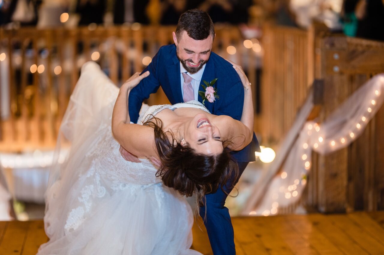 groom dipping bride at caberfae peaks