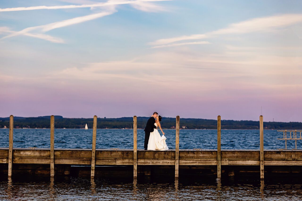 bride and groom at sunset on dock at Charlevoix yacht club