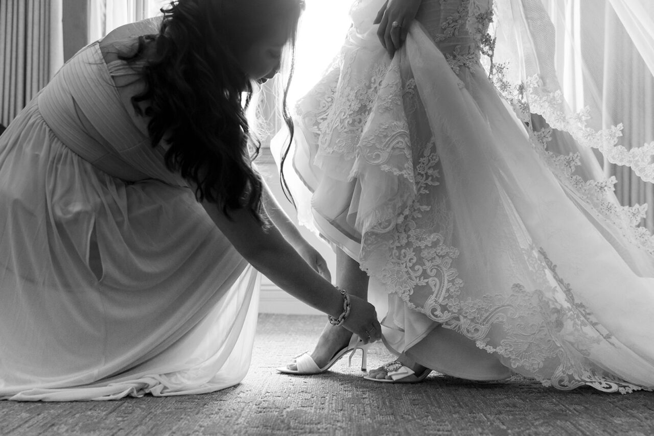 bride having shoes put on